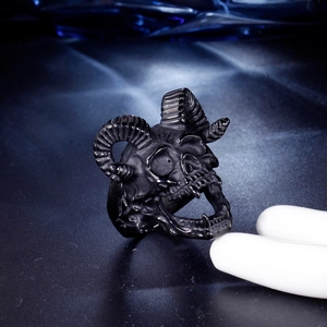 Macro shot of a punk ram skull ring with horns in vintage black stainless steel finish