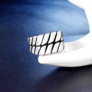 Industrial style stainless steel ring with double row tire tread pattern and brushed finish