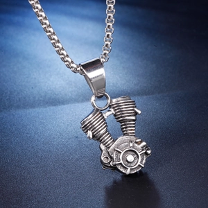 Close-up of vintage silver engine pendant necklace with V-twin motor detailing