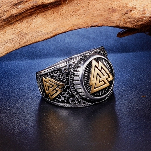 Macro detail of Viking Valknut ring in steel with vintage silver and gold finish