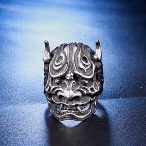 Macro shot of retro stainless steel skull ring with vintage blackened Hannya mask detail