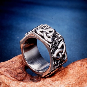 Macro view of vintage stainless steel ring featuring Celtic Triquetra symbols and textures