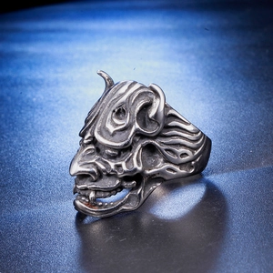 Retro stainless steel skull ring with punk style mask design on dark blue background