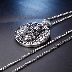 Detail of vintage ape pendant with Ugly Fang engraving and stainless steel box chain