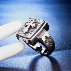 Macro detail of retro cross ring with 'IN GOD' relief on book-shaped stainless steel band