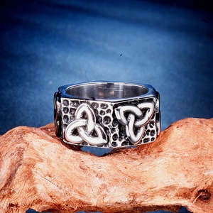 Detail of vintage silver stainless steel ring with Celtic knot and hammered texture