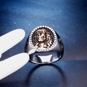 Macro detail of men's stainless steel ring featuring a two-tone Jesus crucifix relief