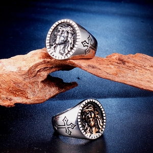 Men's vintage stainless steel Jesus head ring with side cross details on wood base