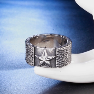 Vintage punk titanium steel ring for men featuring a star emblem and hammered texture