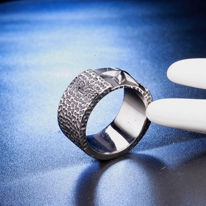 Macro shot of punk style stainless steel ring with hammered texture and star detail