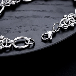 Silver titanium steel bracelet with lobster clasp and intricate hollow link design