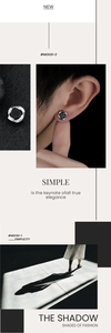 Detail of Mobius magnetic stud earrings with silver metal twist and black stone inlay