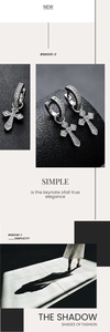 Gros plan de boucles d'oreilles croix en argent avec pierres de zircon dans un style minimaliste