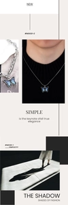 Detail of blue flame butterfly pendant with snake and link chain necklace textures