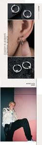 Close-up of silver hoop earrings with three charms shown on a model with street style