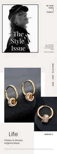Detail shot of gold hoop earrings with sparkling zircon-encrusted cylinder pendants