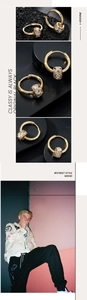 Macro view of gold hoop earrings with pavé-set zircon pendant and hinge clasp detail