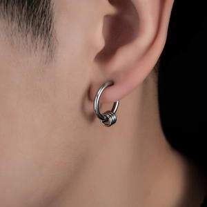 Polished silver hoop earrings with three movable rings for a layered minimalist style