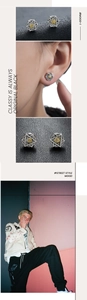 Detail of retro silver hexagram ear clips with gold eye motif on model's ear