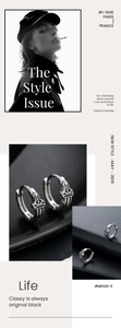 Macro detail of silver cross hoop earrings with sword patterns on black leather texture