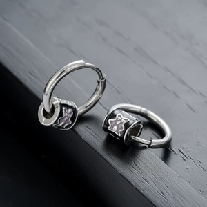 Sleek stainless steel hoop earrings with black cylinders and purple star pattern