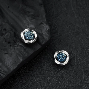 Modern Mobius magnetic earring with blue stone center in silver tone finish