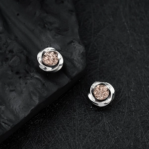 Silver Mobius magnetic earrings with champagne crystal cluster on black volcanic rock