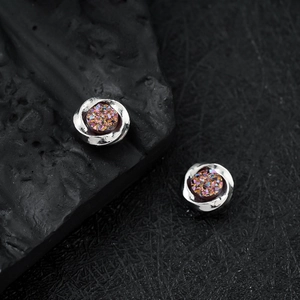 Mobius magnetic stud earrings featuring a purple iridescent druzy inlay and silver swirl design