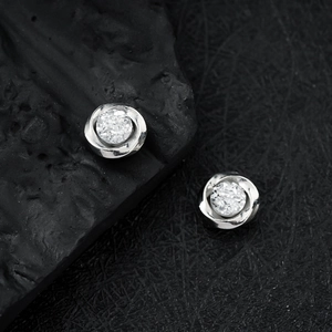 Silver flower-shaped magnetic ear studs with cluster of cubic zirconia in spiral design