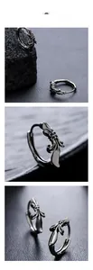 Macro detail of vintage silver cross hoop earrings with engraved floral gothic patterns