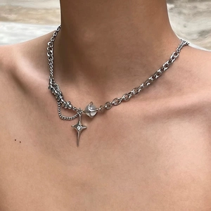 Detail of silver starburst and opal stone pendant on mixed chain Y2K necklace