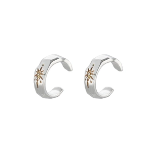 Vintage silver ear cuffs with golden sunburst star pattern and hammered metal texture