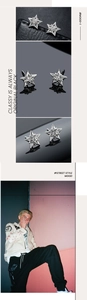 Détails macro des boucles d'oreilles pentagramme argentées avec diamant au centre