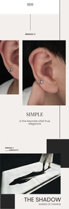 Macro detail showing a polished silver star ear cuff worn on the ear cartilage
