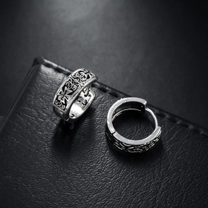 Retro silver cross earrings with gothic hollow engraving on black leather background