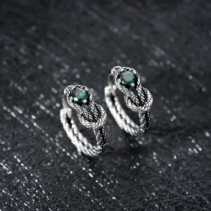 Retro silver snake knot earrings featuring a polished round emerald green gemstone