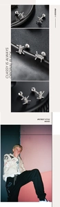 Detailed macro view of silver barbed wire stud earrings with a stylish street punk aesthetic