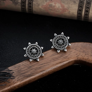 Vintage industrial gear earrings with floral engraving in distressed stainless steel