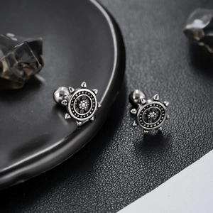 Retro stainless steel nautical helm stud earrings with a punk industrial aesthetic