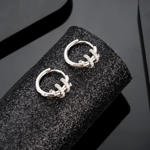 Silver snake hoop earrings with micro-set zircon on black luxury jewelry display