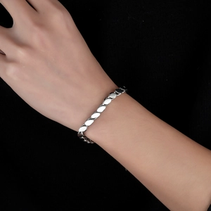 Minimalist silver titanium steel bracelet with polished eye-shaped links on wrist