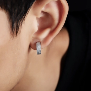 Mens minimalist silver frosted titanium steel clip-on earring on a male model