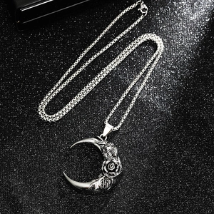 Gothic rose moon pendant necklace with vintage silver finish and starry sand background