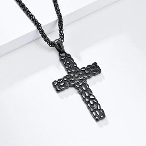 Vintage black stainless steel cross necklace with pebble texture on a minimalist stand