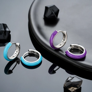 Classic C-shaped enamel hoop earrings in sky blue and purple with a metallic finish