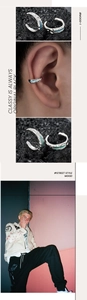 Detailed macro view of irregular silver liquid metal ear cuff with green enamel inlay