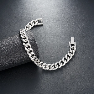 Close-up of polished silver titanium steel Cuban chain bracelet with folding clasp