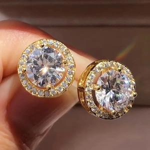 Classic gold halo stud earrings featuring round brilliant cut center stone and pavé accents