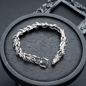 Close-up of retro dragon head bracelet with detailed scales and punk metal texture