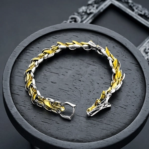 Detail of vintage dragon head bracelet featuring intricate metal scales and bi-color finish